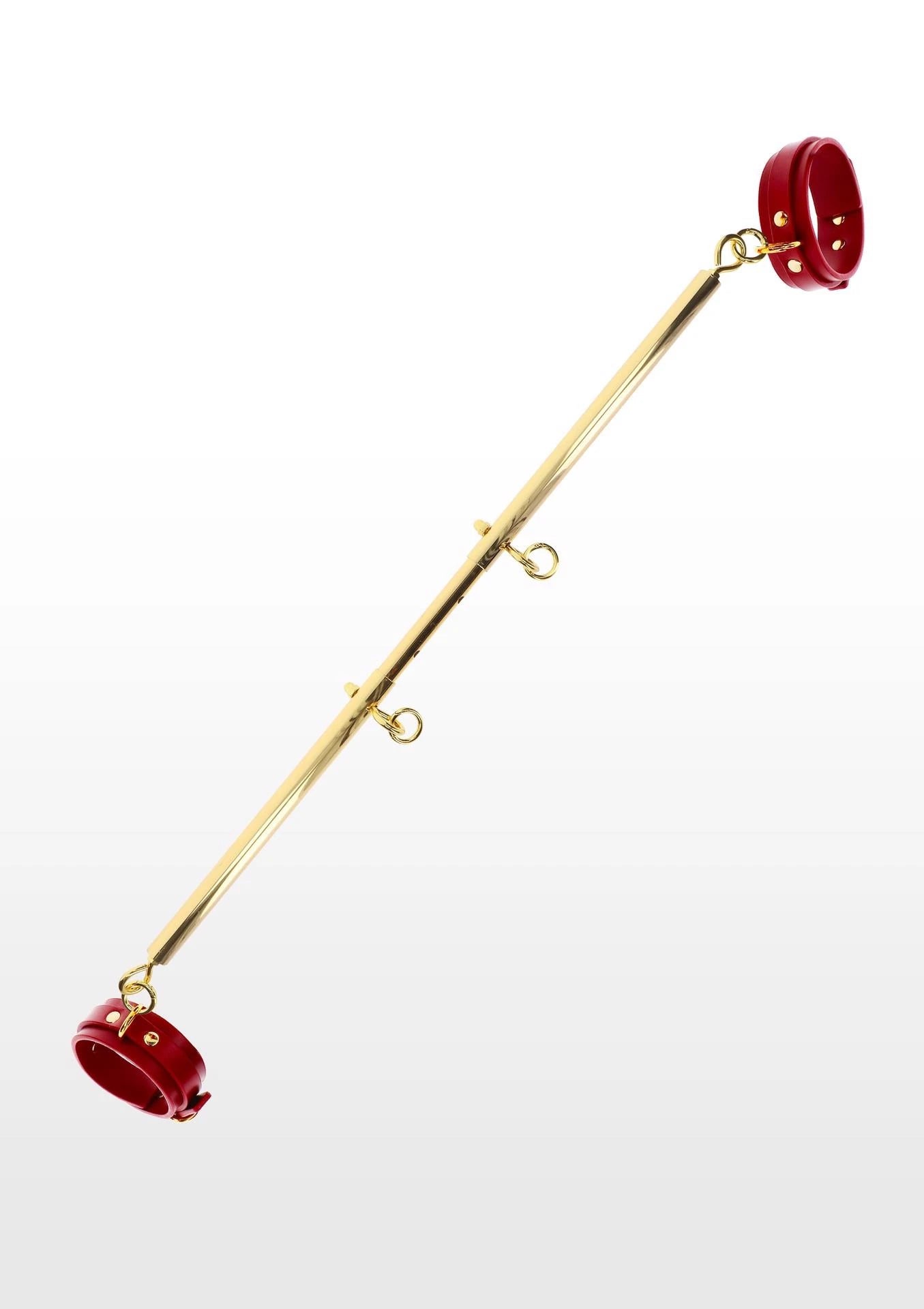 Barre d'écartement avec menottes de cheville rouges