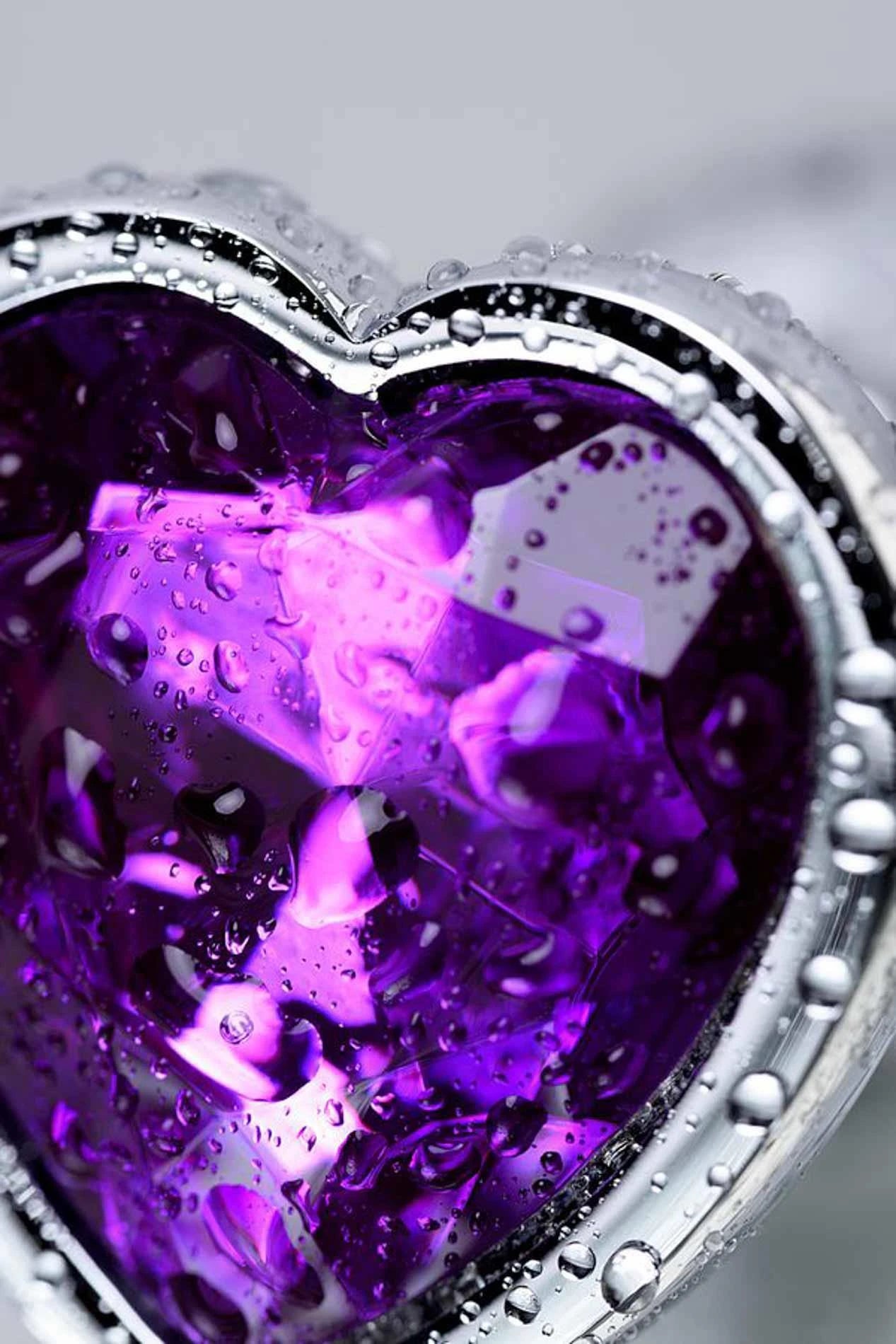 Silver anal plug with purple heart-shaped gem