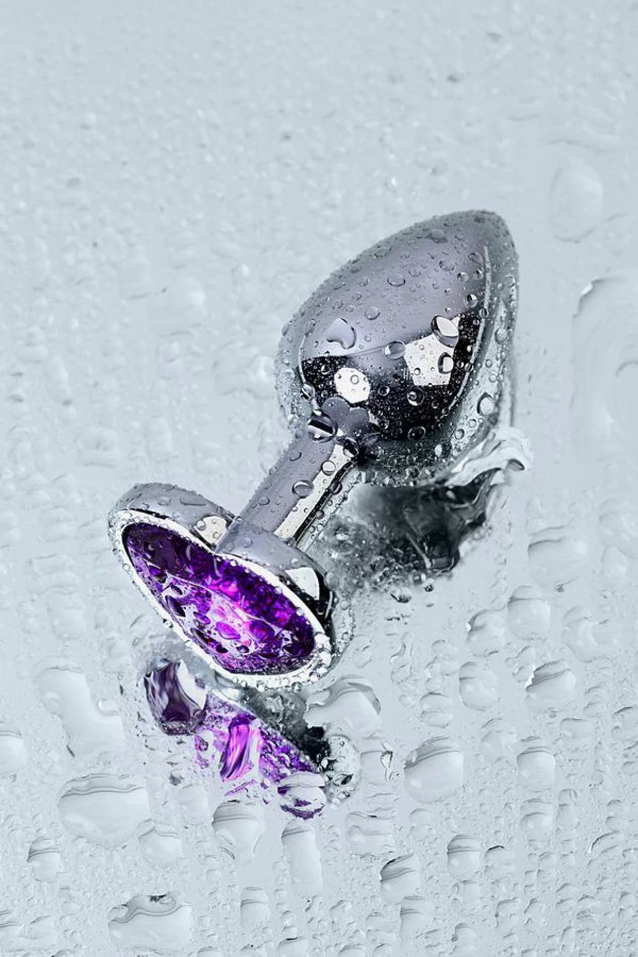 Silver anal plug with purple heart-shaped gem